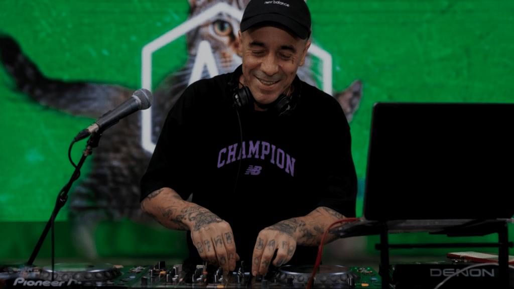 DJ performing with reactive live visuals at a rave using DJMirror Pulse