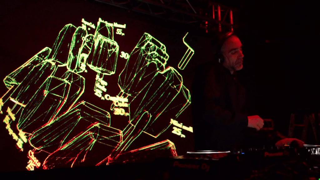 Solo DJ behind the booth with LED wall backdrop and DMX moving heads reacting to music