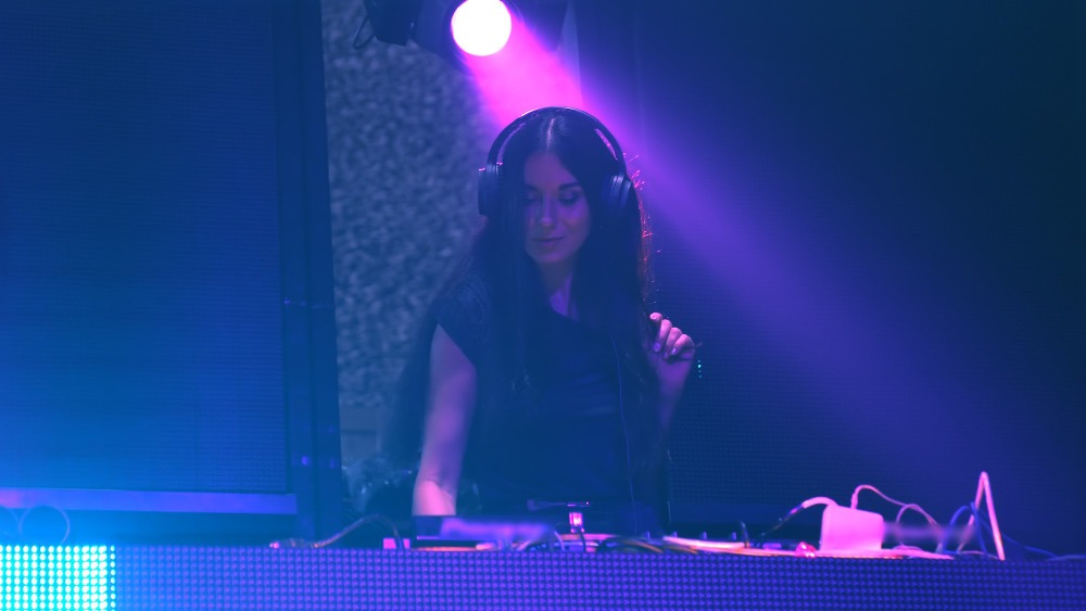 DJ performing with LED wall behind their booth